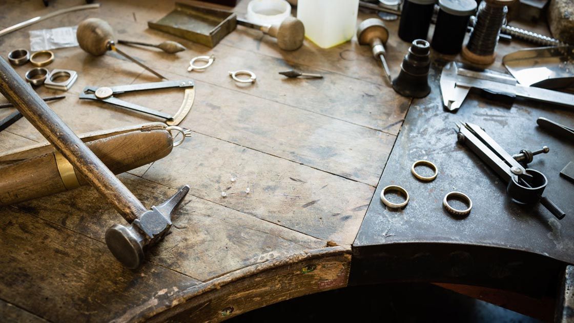 Jewelers' bench with tools and findings on the surface
